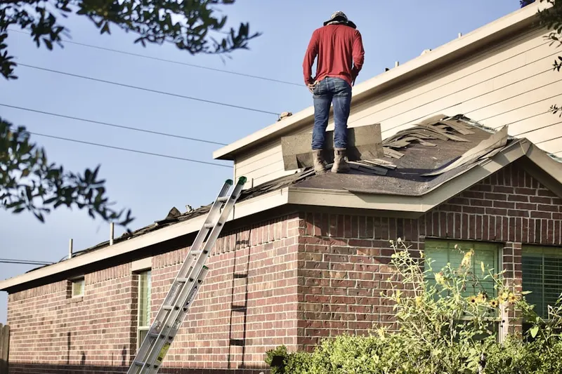Professional roofer working on a residential roof in Fox Trace